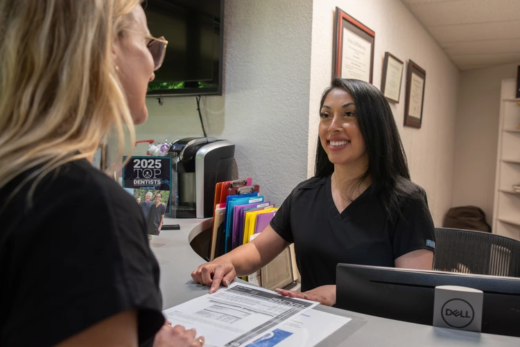 Desk person taking with a patient