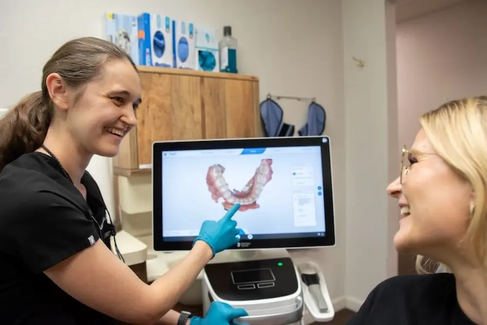 Dentist showing the screen to the patient